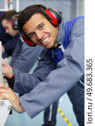 young worker in electrical switchgear room. Стоковое фото, агентство Ingram Publishing / Фотобанк Лори
