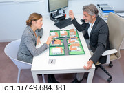 the executives discussing housing development. Стоковое фото, агентство Ingram Publishing / Фотобанк Лори