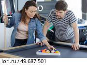 couple forming set of billiard balls by triangle. Стоковое фото, агентство Ingram Publishing / Фотобанк Лори