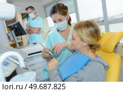 dentist curing a woman patient in the dental office. Стоковое фото, агентство Ingram Publishing / Фотобанк Лори