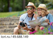 couple with map of ancient town deciding where to go. Стоковое фото, агентство Ingram Publishing / Фотобанк Лори
