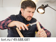 man carpenter with screwdriver in hand working. Стоковое фото, агентство Ingram Publishing / Фотобанк Лори