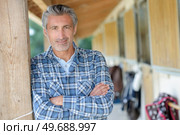 a rancher is at stables. Стоковое фото, агентство Ingram Publishing / Фотобанк Лори