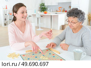 a game of scrabble with an old woman. Редакционное фото, агентство Ingram Publishing / Фотобанк Лори