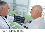 a doctor is examining x-ray. Стоковое фото, агентство Ingram Publishing / Фотобанк Лори