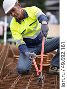man holding metal reinforcing scissors for cutting iron bars. Стоковое фото, агентство Ingram Publishing / Фотобанк Лори