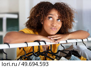 young woman deciding what to put on. Стоковое фото, агентство Ingram Publishing / Фотобанк Лори