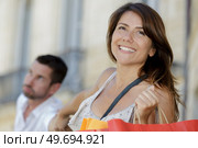woman pulling her mans hand to continue shopping. Стоковое фото, агентство Ingram Publishing / Фотобанк Лори