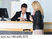 checking the reservation list. Стоковое фото, агентство Ingram Publishing / Фотобанк Лори