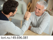the father and son doing arm wresteling. Стоковое фото, агентство Ingram Publishing / Фотобанк Лори
