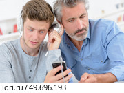 two men listening to the music. Стоковое фото, агентство Ingram Publishing / Фотобанк Лори