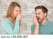 female disgusted by boyfriend breath. Стоковое фото, агентство Ingram Publishing / Фотобанк Лори