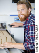 young happy man using a wood shaper. Стоковое фото, агентство Ingram Publishing / Фотобанк Лори