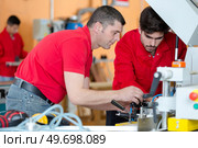 two workers on milling machine. Стоковое фото, агентство Ingram Publishing / Фотобанк Лори