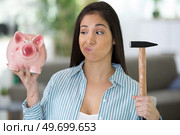 upset woman with piggy bank at home. Стоковое фото, агентство Ingram Publishing / Фотобанк Лори
