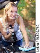 woman wipes and cleans the interior of her car. Стоковое фото, агентство Ingram Publishing / Фотобанк Лори