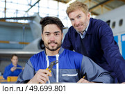 beaming workers having job at airdrome. Стоковое фото, агентство Ingram Publishing / Фотобанк Лори