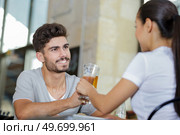 young couple in bar chinking glasses. Стоковое фото, агентство Ingram Publishing / Фотобанк Лори