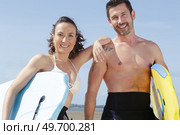 two surfers looking at camera. Стоковое фото, агентство Ingram Publishing / Фотобанк Лори