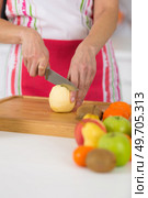 close-up on mature female hands slicing apples on chopping board. Стоковое фото, агентство Ingram Publishing / Фотобанк Лори