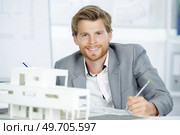 scale model of houses and happy architect. Стоковое фото, агентство Ingram Publishing / Фотобанк Лори