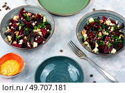 Salad of boiled beetroot, cheese, prunes and nuts. Healthy beet salad on gray background. Beet or beetroot salad with nuts. Стоковое фото, агентство Ingram Publishing / Фотобанк Лори