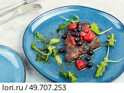 Fried beef fillet medallion steak with berry sauce on the table. Healthy food.. Beef steak roasted in berry sauce. Стоковое фото, агентство Ingram Publishing / Фотобанк Лори