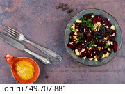 Tasty vegan salad of beetroot, cheese, prunes and nuts. Delicious red beet salad with walnuts. Стоковое фото, агентство Ingram Publishing / Фотобанк Лори