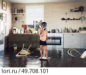 kids pday on the table while flooding in the kitchen. Photo and media photocombination. Стоковое фото, агентство Ingram Publishing / Фотобанк Лори