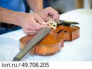 close up of hands fixing the string. Стоковое фото, агентство Ingram Publishing / Фотобанк Лори