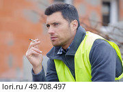 smoking cigarette on construction site. Стоковое фото, агентство Ingram Publishing / Фотобанк Лори