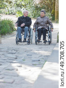 Elderly couple promenading in wheelchairs. Стоковое фото, агентство Ingram Publishing / Фотобанк Лори
