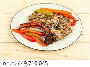Fried tomahawk pork meat steak on wooden table.. Grilled Tomahawk steak. Стоковое фото, агентство Ingram Publishing / Фотобанк Лори