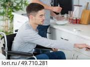 couple cooking together - man disabled on wheelchair. Стоковое фото, агентство Ingram Publishing / Фотобанк Лори