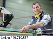 portrait of male engineer with cad drawings in factory. Стоковое фото, агентство Ingram Publishing / Фотобанк Лори