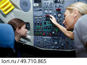 young female aviation technician learning the panel. Стоковое фото, агентство Ingram Publishing / Фотобанк Лори