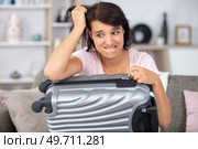 troubled woman has forgotten the code for her suitcase lock. Стоковое фото, агентство Ingram Publishing / Фотобанк Лори