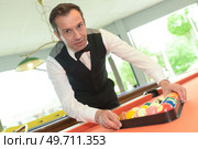 man tidying up bool billiard equipment. Стоковое фото, агентство Ingram Publishing / Фотобанк Лори