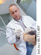 senior woman receives foot examination from gloved podiatrist. Стоковое фото, агентство Ingram Publishing / Фотобанк Лори