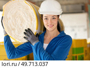 female construction worker with roll of insulating material. Стоковое фото, агентство Ingram Publishing / Фотобанк Лори