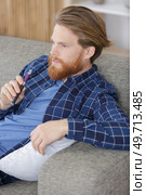 young man smokes an electronic cigarette at home. Стоковое фото, агентство Ingram Publishing / Фотобанк Лори