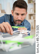 middle aged man assembling a drone. Стоковое фото, агентство Ingram Publishing / Фотобанк Лори