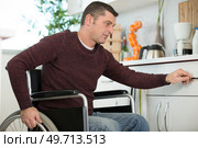 man on wheelchair in the kitchen. Стоковое фото, агентство Ingram Publishing / Фотобанк Лори