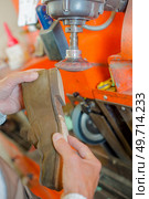 a cobbler filing a sole. Стоковое фото, агентство Ingram Publishing / Фотобанк Лори