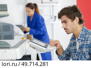 man using control pad on printer. Стоковое фото, агентство Ingram Publishing / Фотобанк Лори