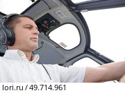 a concentrated helicopter pilot flying. Стоковое фото, агентство Ingram Publishing / Фотобанк Лори