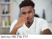 young black man suffering from sinusitis. Стоковое фото, агентство Ingram Publishing / Фотобанк Лори