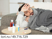 bearded sick man with flue sitting on sofa at home. Стоковое фото, агентство Ingram Publishing / Фотобанк Лори
