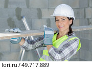 female labourer carrying length of wood on her shoulder. Стоковое фото, агентство Ingram Publishing / Фотобанк Лори