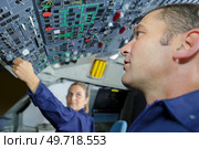 man and woman pilots in a cockpit. Стоковое фото, агентство Ingram Publishing / Фотобанк Лори